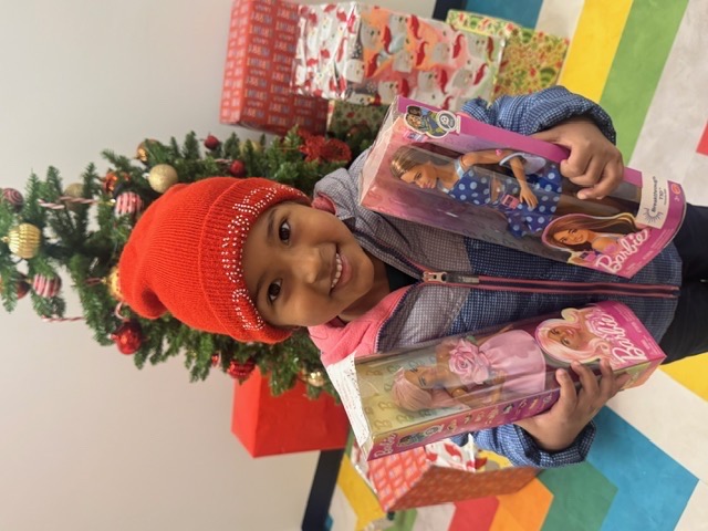 little girl with barbie dolls